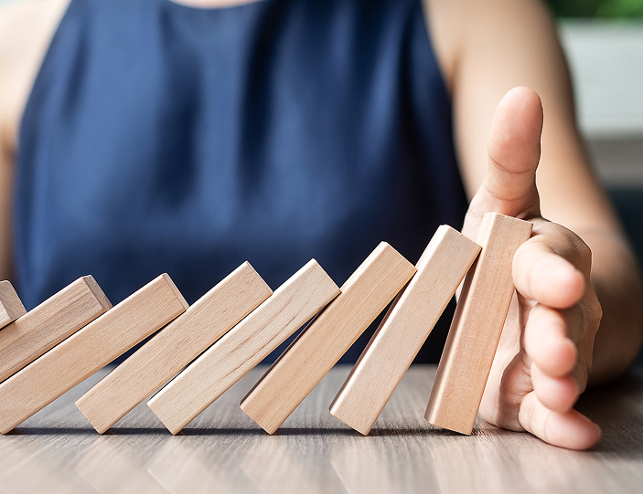 Hand stopping dominoes - preventing escalating risk